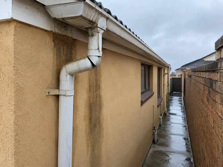 Illustration of a damaged gutter junction and downpipe
