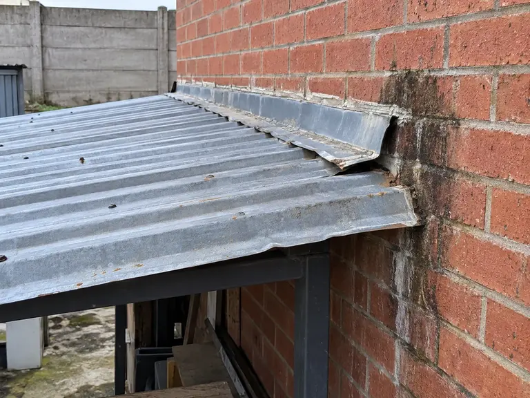 Illustration of a weathered roof-to-wall flashing junction